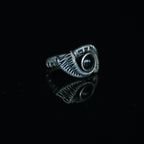Three-quarter view of The Eclipse natural black obsidian ring showing its hand-shaped brass
wirework