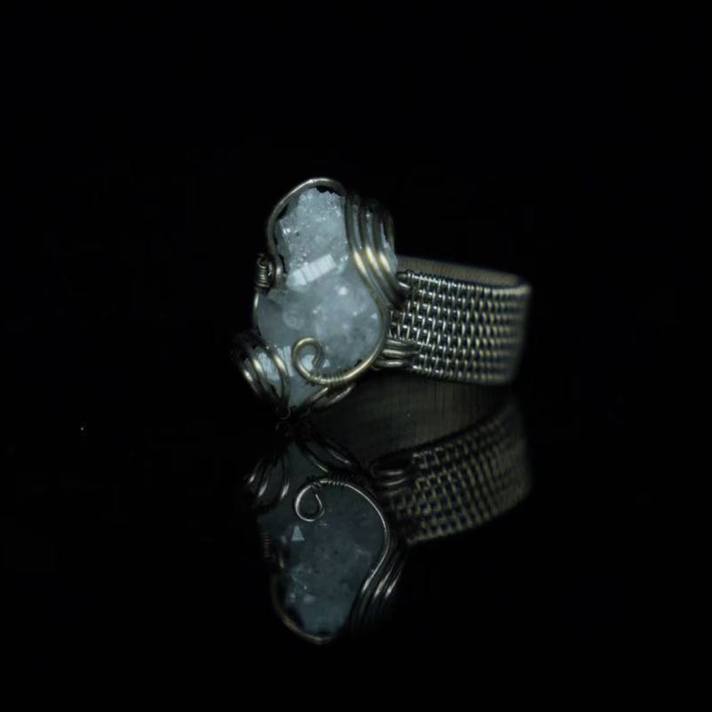 Side view of The Quiet Frost natural crystal cluster ring showing its white copper wirework andring band