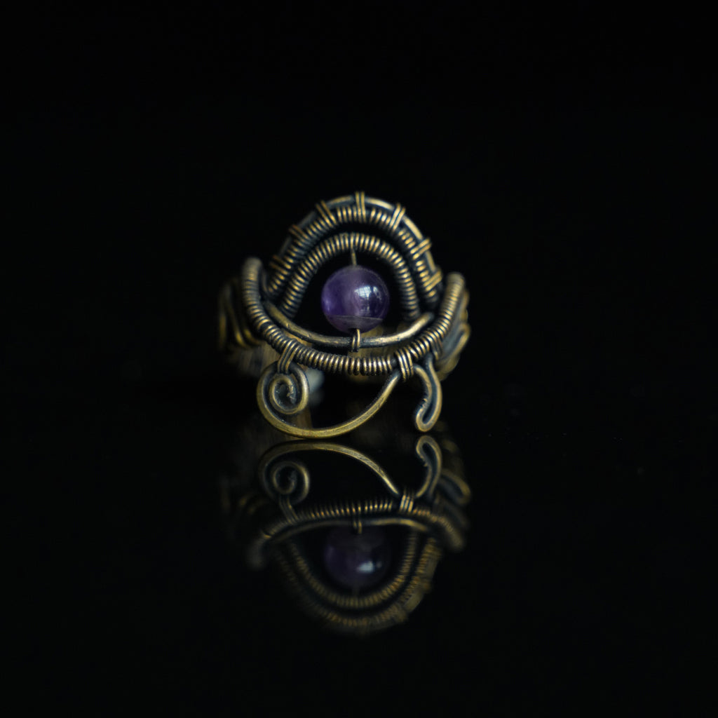 The Timekeeper natural amethyst ring with hand-shaped brass wirework, front view