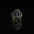 The Timekeeper natural amethyst ring with hand-shaped brass wirework, front view