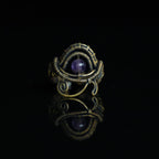 The Timekeeper natural amethyst ring with hand-shaped brass wirework, front view