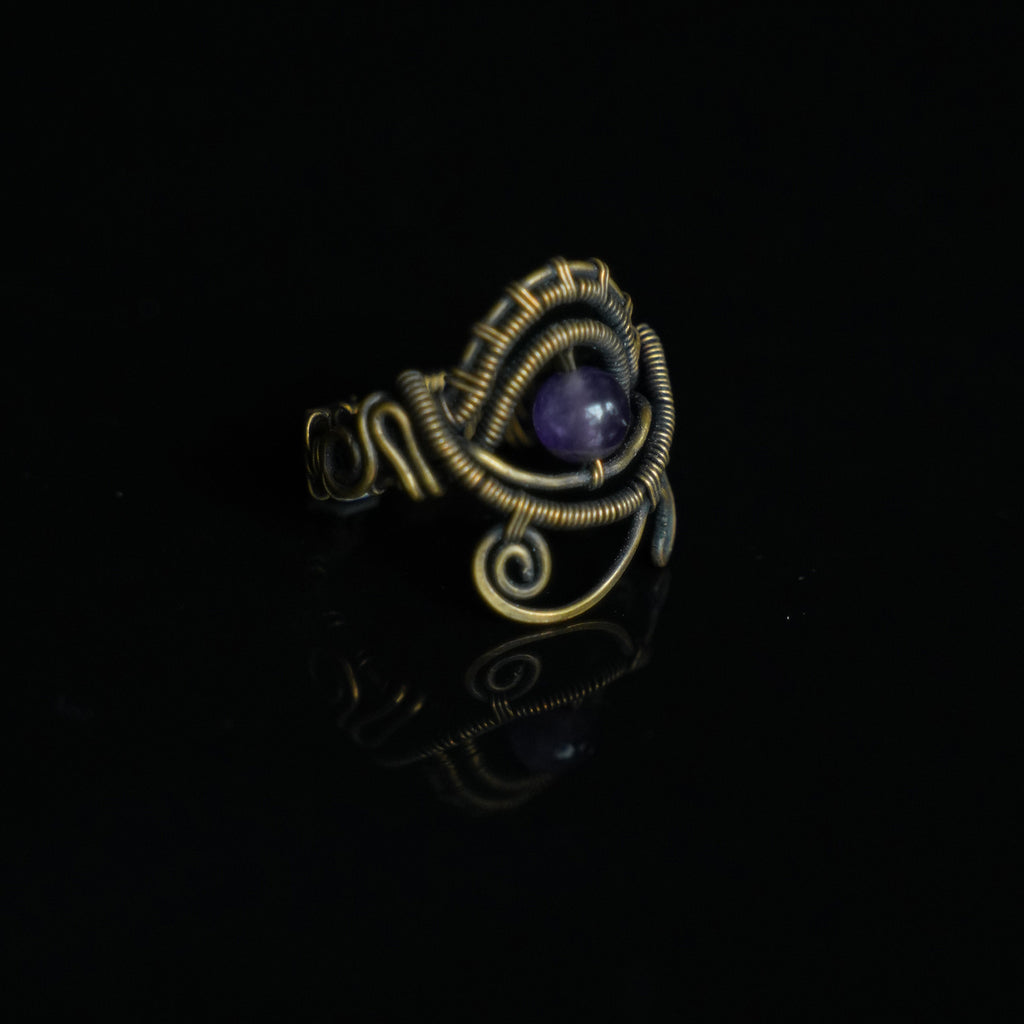 One-of-a-kind natural amethyst ring showing sculptural brass wirework