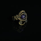 One-of-a-kind natural amethyst ring showing sculptural brass wirework