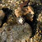 The Veil natural labradorite and brass wire-wrapped ring held for scale