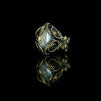 Side view of The Veil labradorite ring showing its sculptural brass wirework
